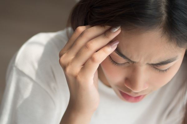 Portrait of stressed and sick woman with headache